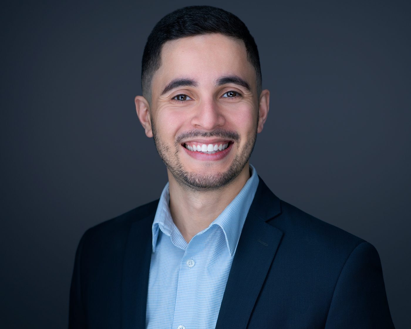 Dan Larrazabal, LCSW, smiling in a navy blazer
